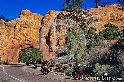 BRYCE CANYON, UTAH, JUNE, 07, 2018: Outdoor view of motorcyclists in the road crossing throught the red arch road tunnel Editorial Stock Photo
