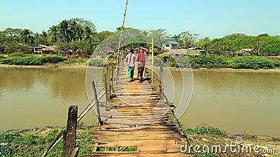Two women on a wooden bridge in Myanmar Editorial Stock Photo