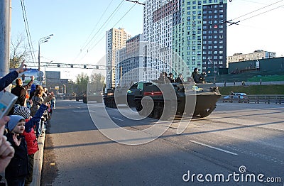 BTR-MDM column `Shell` with soldiers of army goes around the city, and crowd of people welcome them, waves a hand. Editorial Stock Photo