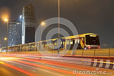 BTS train station and traffic night light car motion on highway in BANGKOK THAILAND Editorial Stock Photo