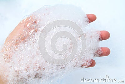 Bubble foam in hand Stock Photo