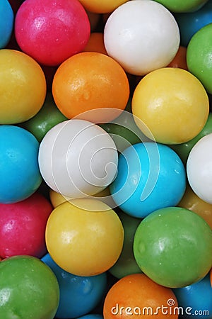Bubble gum chewing gum texture. Rainbow multicolored gumballs chewing gums as background. Round sugar coated candy Stock Photo