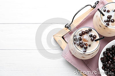 Bubble milk tea with tapioca balls on white wooden table, top view. Space for text Stock Photo