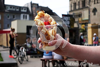 Bubble waffles with ice cream in hand. Hong kong waffle . Bubble waffles with strawberries, whipped cream and marshmallow are sold Stock Photo