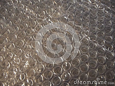 Bubble wrap is a pliable transparent plastic material used for packing fragile items. Regularly spaced, protruding air-filled Stock Photo