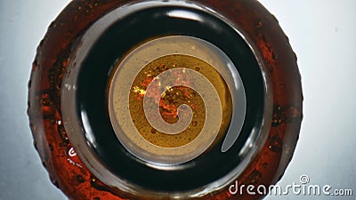 Bubbled craft swishing flask closeup. Overflowing beer waving splashing bottle Stock Photo