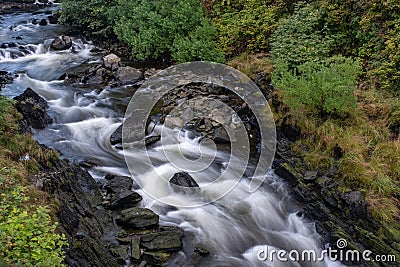 The bubbling Ketchikan Creek with a long exposure to create blurred motion to the water, close the famous Creek Street in Stock Photo