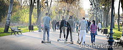 BUCHAREST, ROMANIA, - April 2, 2016: People using hoverboard, a self-balancing two-wheeled board, in the park. Editorial content Editorial Stock Photo