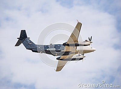 Beechcraft B300 King Air 350 twin-turboprop aircraft flying against blue sky Editorial Stock Photo