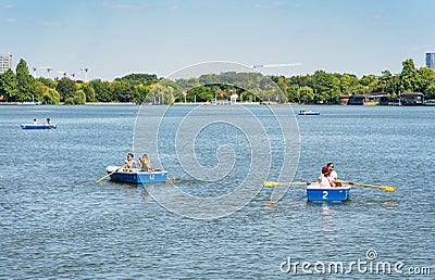 Many people in boats paddling on the lake in King Mihai I park (Herestrau). Couple on a Editorial Stock Photo