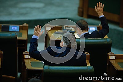 Romanian senators vote bills by raising their hands in a full Senate meeting Editorial Stock Photo