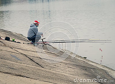 Bucharest/Romania - 11.19.2020: Fisherman on the edge Dambovita Lake Lacul Morii in Bucharest, Romania Editorial Stock Photo