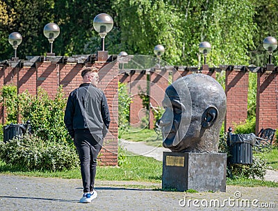 Single man out for a stroll on the alleys in King Mihai I park (Herestrau Editorial Stock Photo