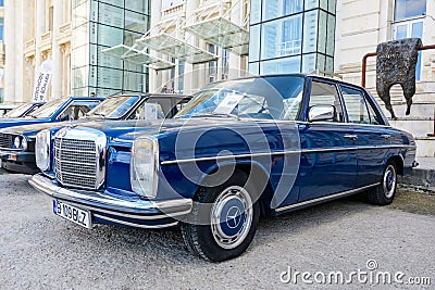 One vivid blue Mercedes 220D (115W) vintage car produced in year 1975 and parked in a street Editorial Stock Photo