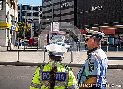 Bucharest/Romania - 09.27.2020: Romanian police officers supervising traffic in the center of Bucharest, Unirii Square Editorial Stock Photo