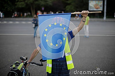 A man holds an European Union flag during an anti-government protest in Bucharest Editorial Stock Photo