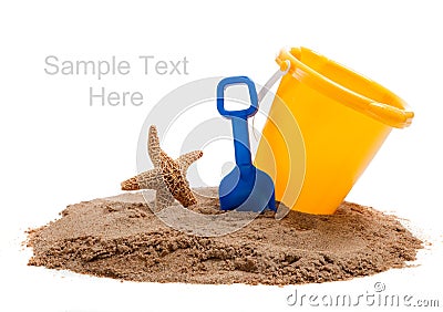 Bucket on beach with blue shovel and starfish Stock Photo