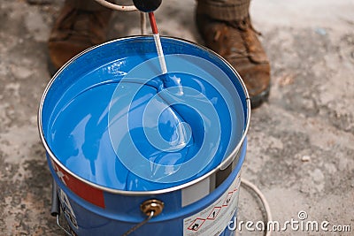 Bucket of blue paint mixing on motion Stock Photo