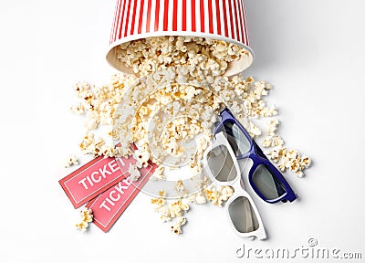 Bucket of fresh popcorn, tickets and 3D glasses on background, top view. Cinema snack Stock Photo