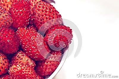 Bucket with red wild strawberry on white background Stock Photo