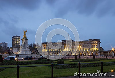 Buckingham palace at night, lit with a warm glow. Editorial Stock Photo