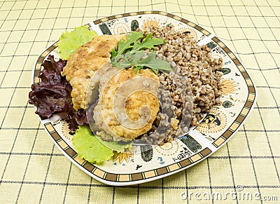 Buckweat with chicken chops amd green salad in the plate Stock Photo