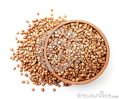 Buckwheat brown raw in a wooden plate on a white background, isolated. Top view Stock Photo