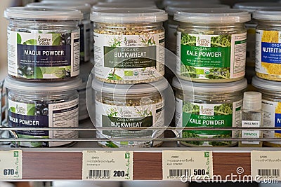 Buckwheat grains along with jars with maqui and kale powders in Lemon Farm organic grocery shop Editorial Stock Photo
