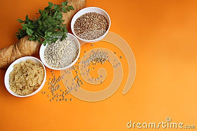 Buckwheat, pearl barley, pasta in plates and bread with dill and parsley Stock Photo