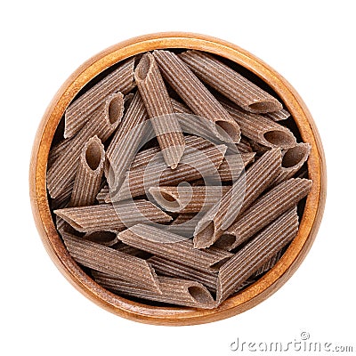 Buckwheat penne, gluten free whole grain pasta, in a wooden bowl Stock Photo