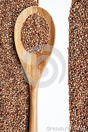 Buckwheat and spoon on a white background. Stock Photo