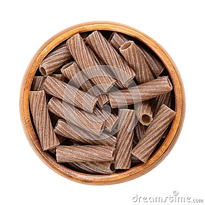 Buckwheat tortiglioni, gluten free whole grain pasta, in a wooden bowl Stock Photo