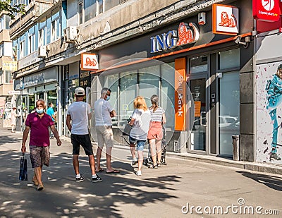 Bucuresti/Romania - 08.18.2020: People waiting in line in front of a ING Bank branch respecting the social distancing to prevent Editorial Stock Photo