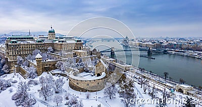 Budapest, Hungary - Aerial panoramic view of the snowy Buda Castle Royal Palace from above with the Szechenyi Chain Bridge Stock Photo