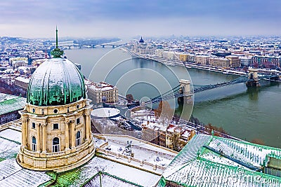 Budapest, Hungary - Aerial view of the dome of snowy Buda Castle Royal Palace from above with the Szechenyi Chain Bridge Stock Photo