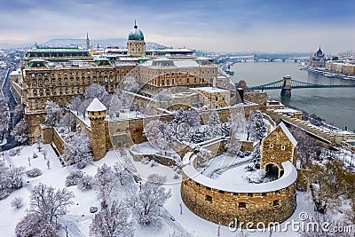 Budapest, Hungary - Aerial view of the snowy Buda Castle Royal Palace from above with the Szechenyi Chain Bridge and Parliament Stock Photo