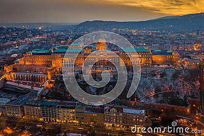 Budapest, Hungary - Aerial view of the snowy Buda Castle Royal Palace with beautiful golden sunset Stock Photo