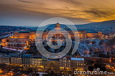 Budapest, Hungary - Aerial view of the snowy Buda Castle Royal Palace with beautiful golden sunset Stock Photo