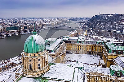 Budapest, Hungary - Aerial view of the snowy Buda Castle Royal Palace with Statue of Liberty, Elisabeth and Liberty Bridge Stock Photo