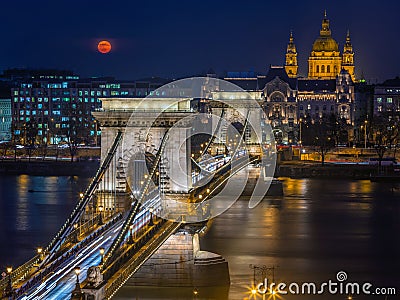 Budapest, Hungary - Blood Moon rising over downtown of Budapest with beautiful Szechenyi Chain Bridge and St. Stephen`s Basilica Editorial Stock Photo