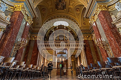 Budapest, Hungary - Feb 8, 2020: Organ pipe facade with golden fresco ceiling in St. Stephen`s Basilica Editorial Stock Photo