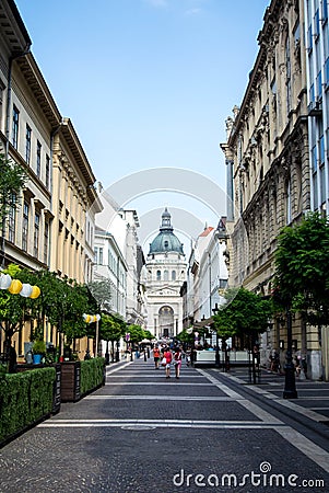 BUDAPEST, HUNGARY - JULY 24, 2016: A street of Budapest and St. Stephen`s Szent Istvan Basilica Editorial Stock Photo