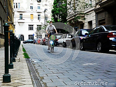 cyclist riding on gray stone paved street of Budapest during the Covid-19 pandemic Editorial Stock Photo