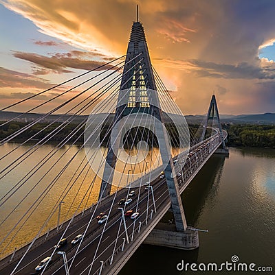 Budapest, Hungary - Megyeri Bridge over River Danube at sunset with heavy traffic, beautiful dramatic clouds Stock Photo