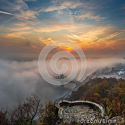 Budapest, Hungary - Mysterious foggy sunrise with Liberty Bridge Szabadsag hid and lookout on Gellert Hill Stock Photo