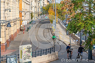 BUDAPEST, HUNGARY - October 25, 2018: Tram rails, random cyclists and buildings Editorial Stock Photo