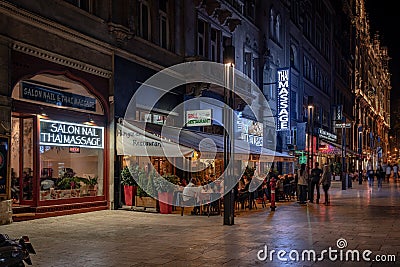 Budapest, Hungary - Outdoor restaurant and Thai massage salons at night Editorial Stock Photo