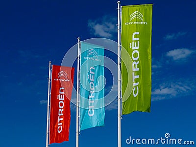 Red, blue and green bright Citroen flags with blue sky background Editorial Stock Photo