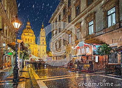 Budapest, Hungary - Snowy night at a Christmas market and shopping street with street-lamp, festive decoration Stock Photo