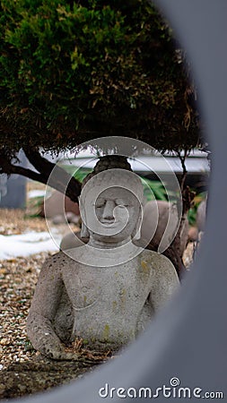 A buddah statue behind a circle Stock Photo